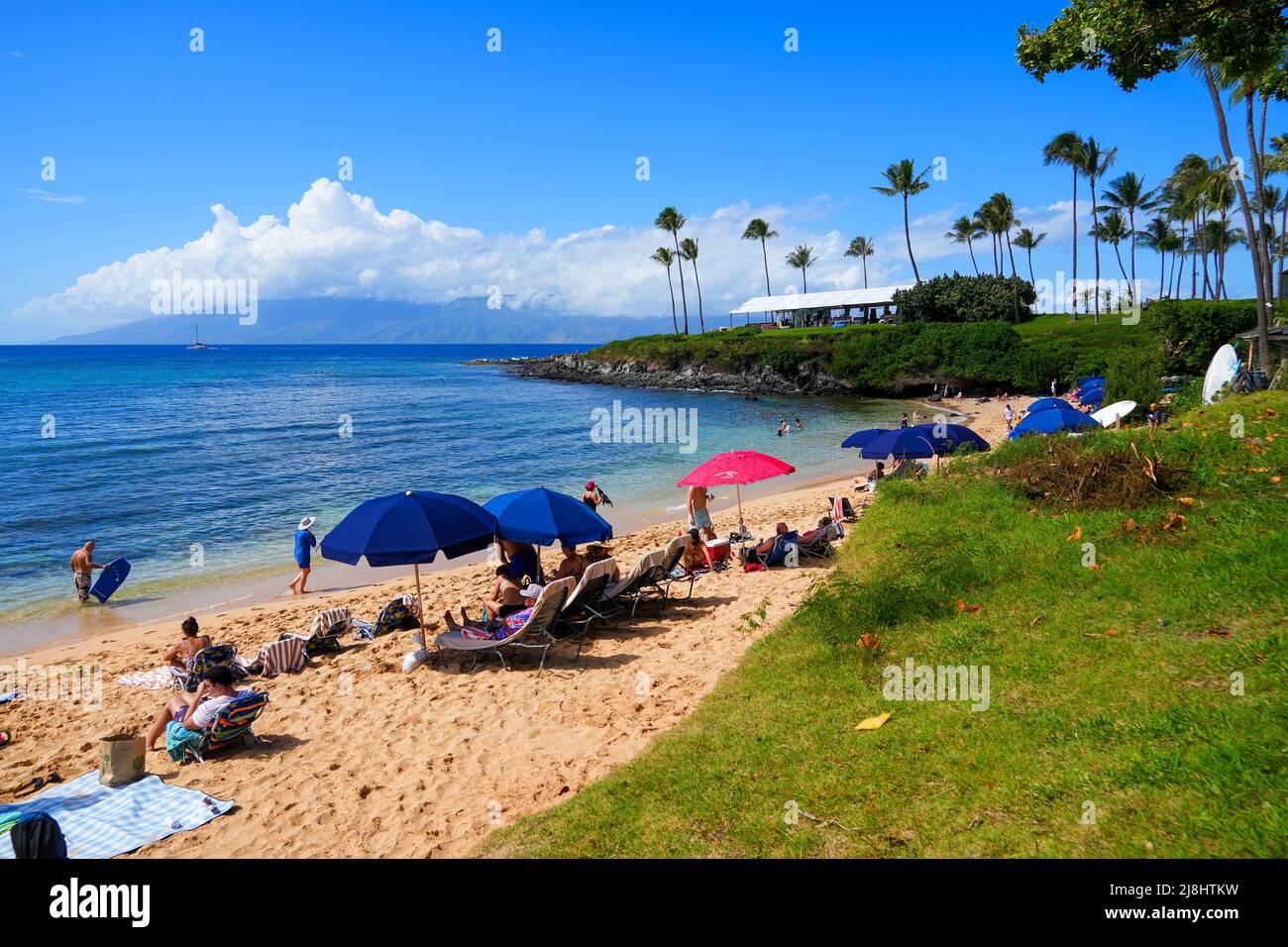 Tourists relaxing on the beach of Kapalua Bay on West Maui, Hawaii, during Spring Break Stock