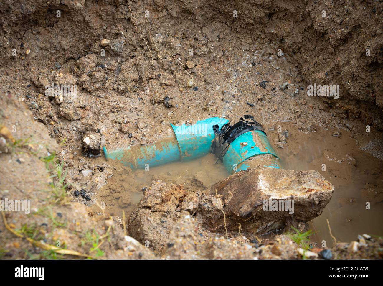 plumbing broken plastic pipe in the hole and water in wait repair Stock Photo