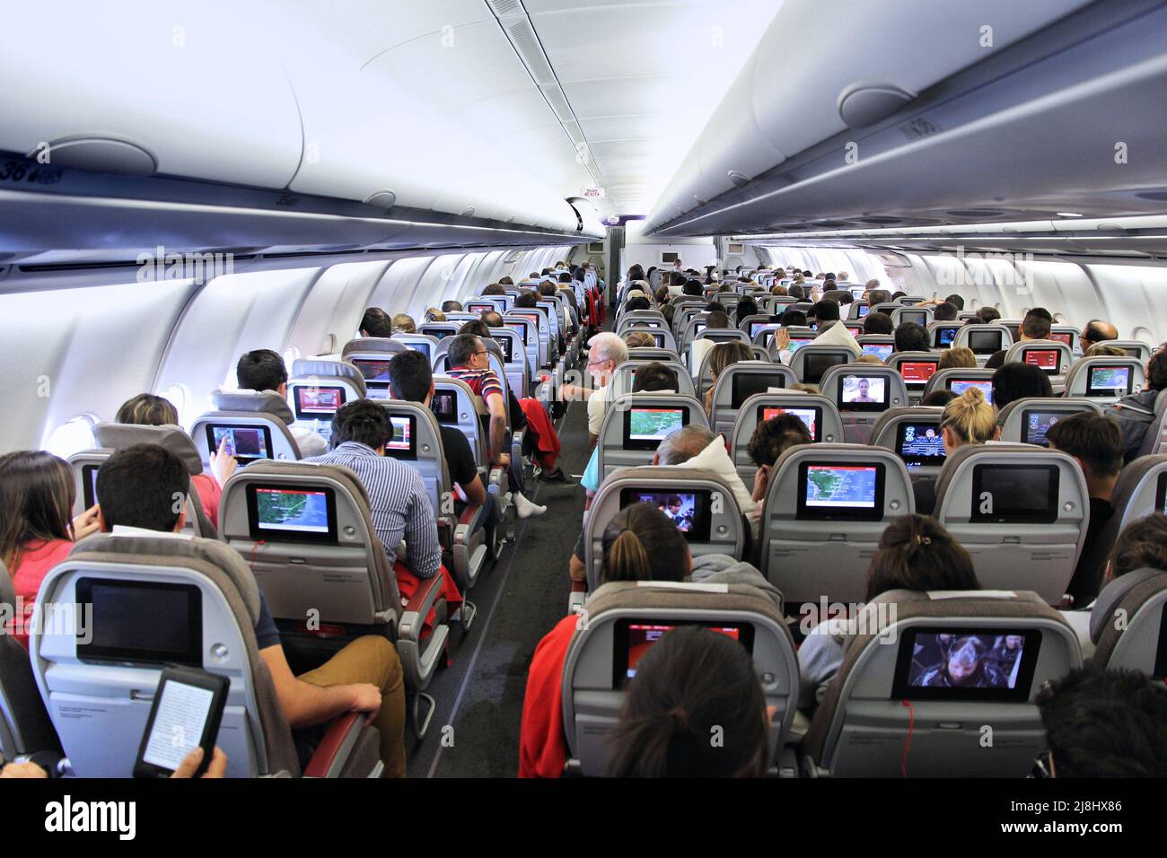 MADRID, SPAIN - OCTOBER 5, 2014: Passengers onboard Iberia Airbus A340 aircraft. Iberia is part of International Airlines Group (IAG, parent company) Stock Photo