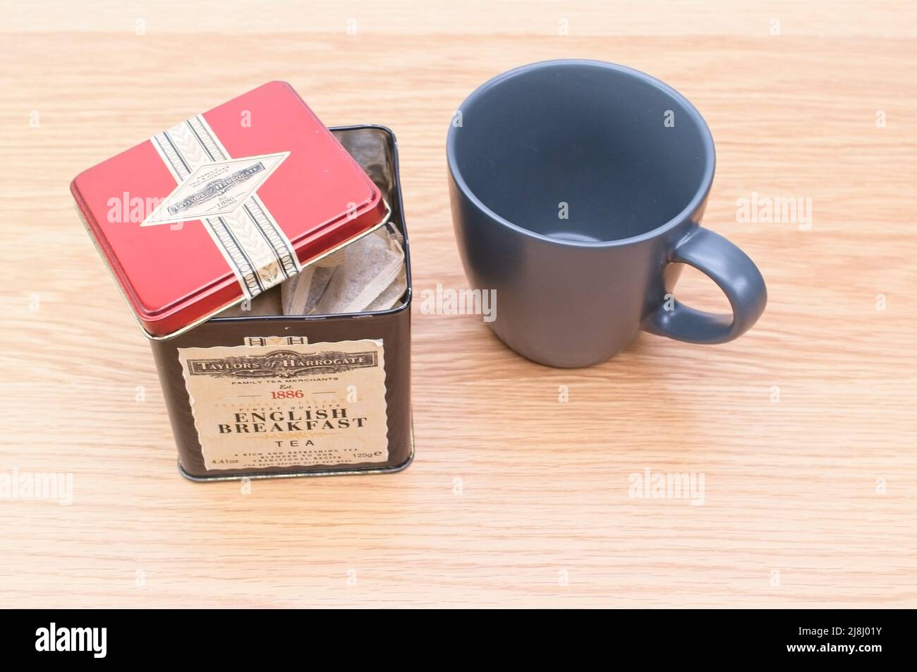 gray tea cup and tea metal box on a table tea time concept Stock