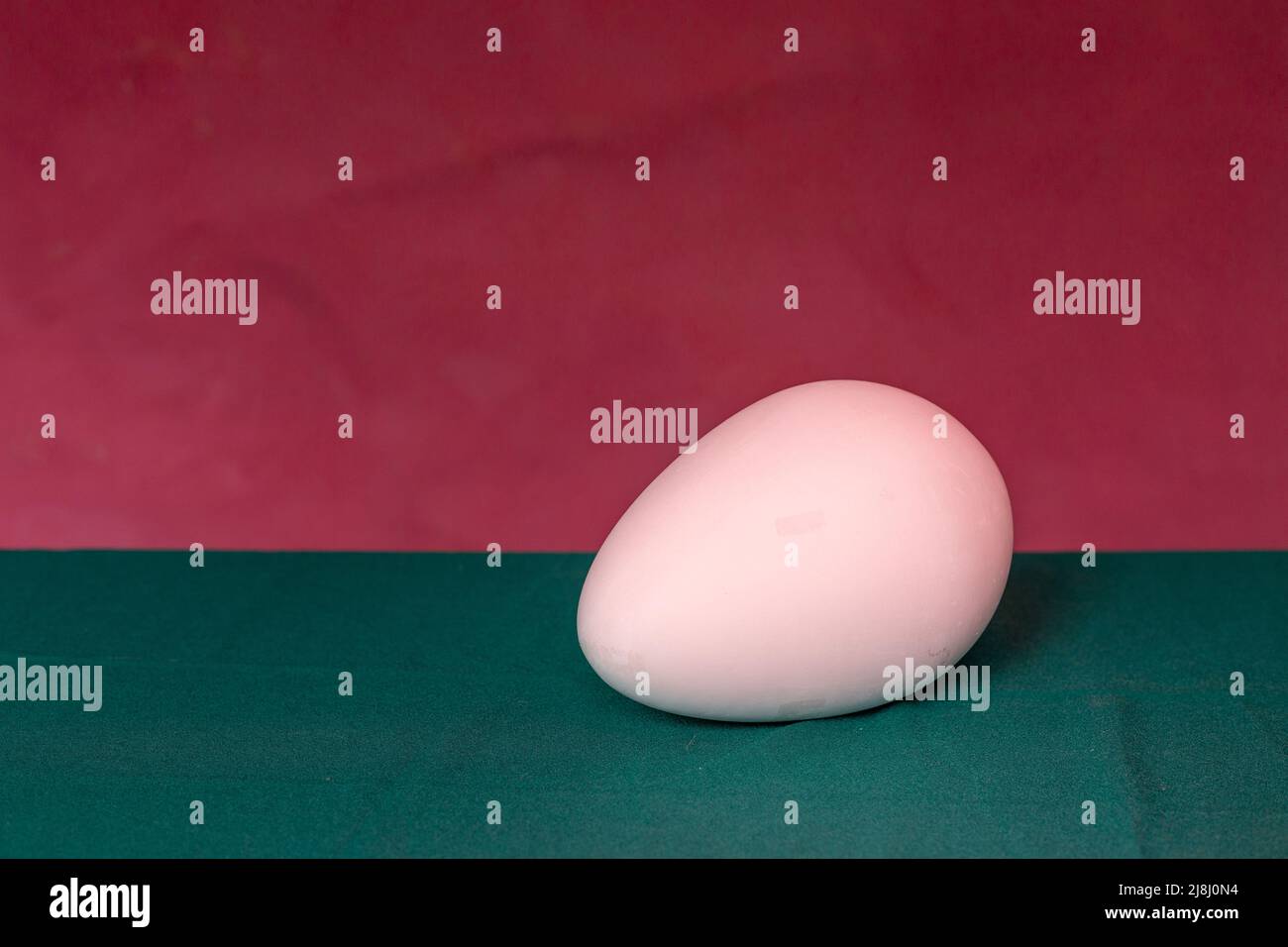 Egg on a uniform background of two colors Stock Photo
