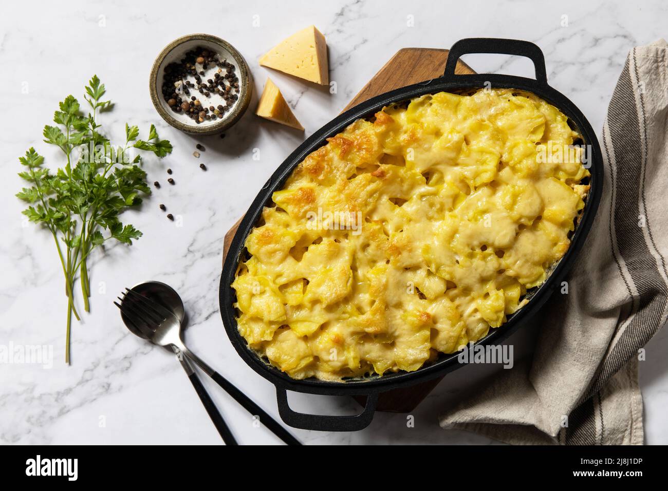 Potato gratin, french cuisine. Healthy casserole or gratin with cream, gratin dauphinois on a gray stone table. Top view flat lay. Stock Photo