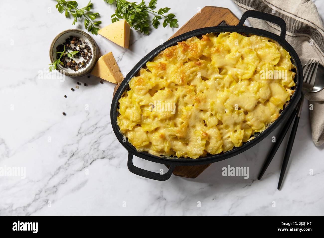 Potato gratin, french cuisine. Healthy casserole or gratin with cream, gratin dauphinois on a gray stone table. Top view flat lay. Copy space. Stock Photo