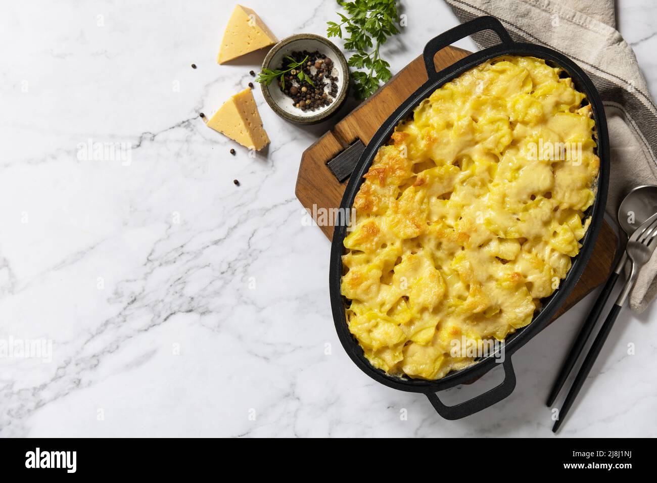 Potato gratin, french cuisine. Healthy casserole or gratin with cream, gratin dauphinois on a gray stone table. Top view flat lay. Copy space. Stock Photo