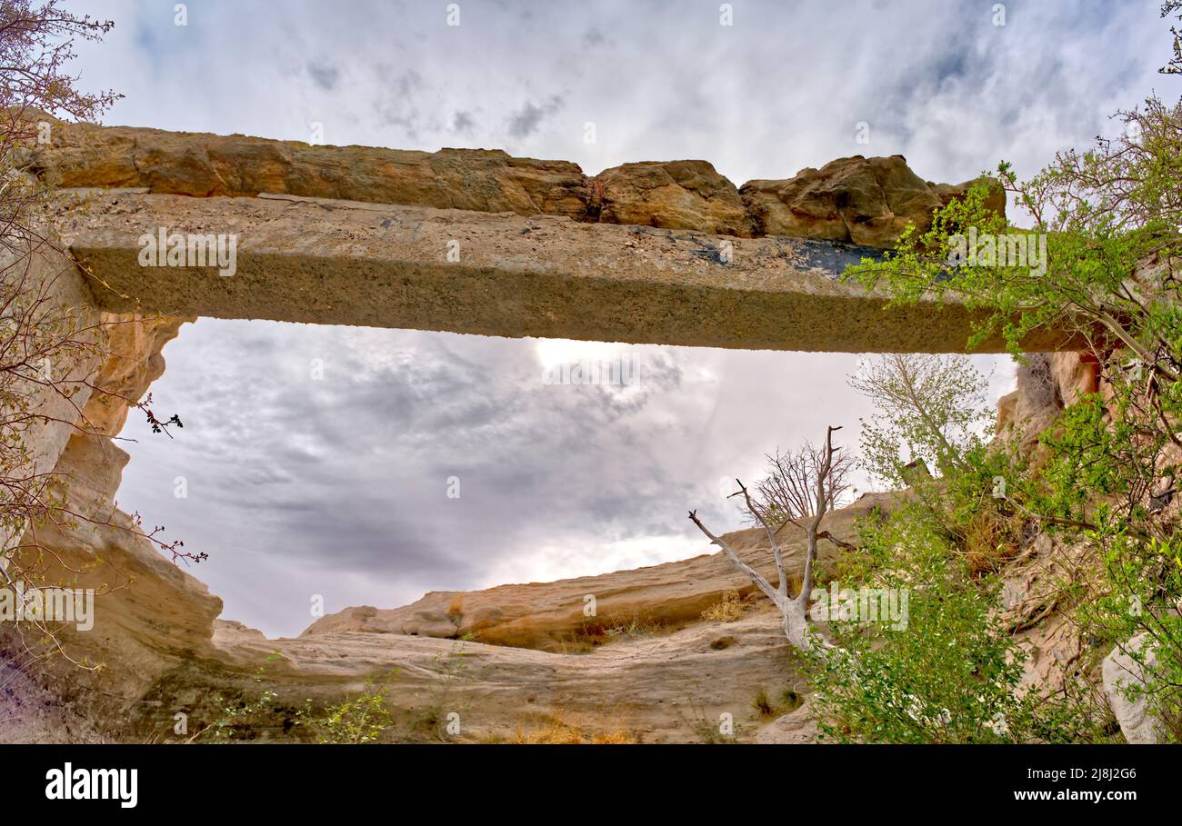 Wide angle view from below Agate Bridge in Petrified Forest National Park Arizona. Due to the fragility of this petrified log a concrete support was b Stock Photo