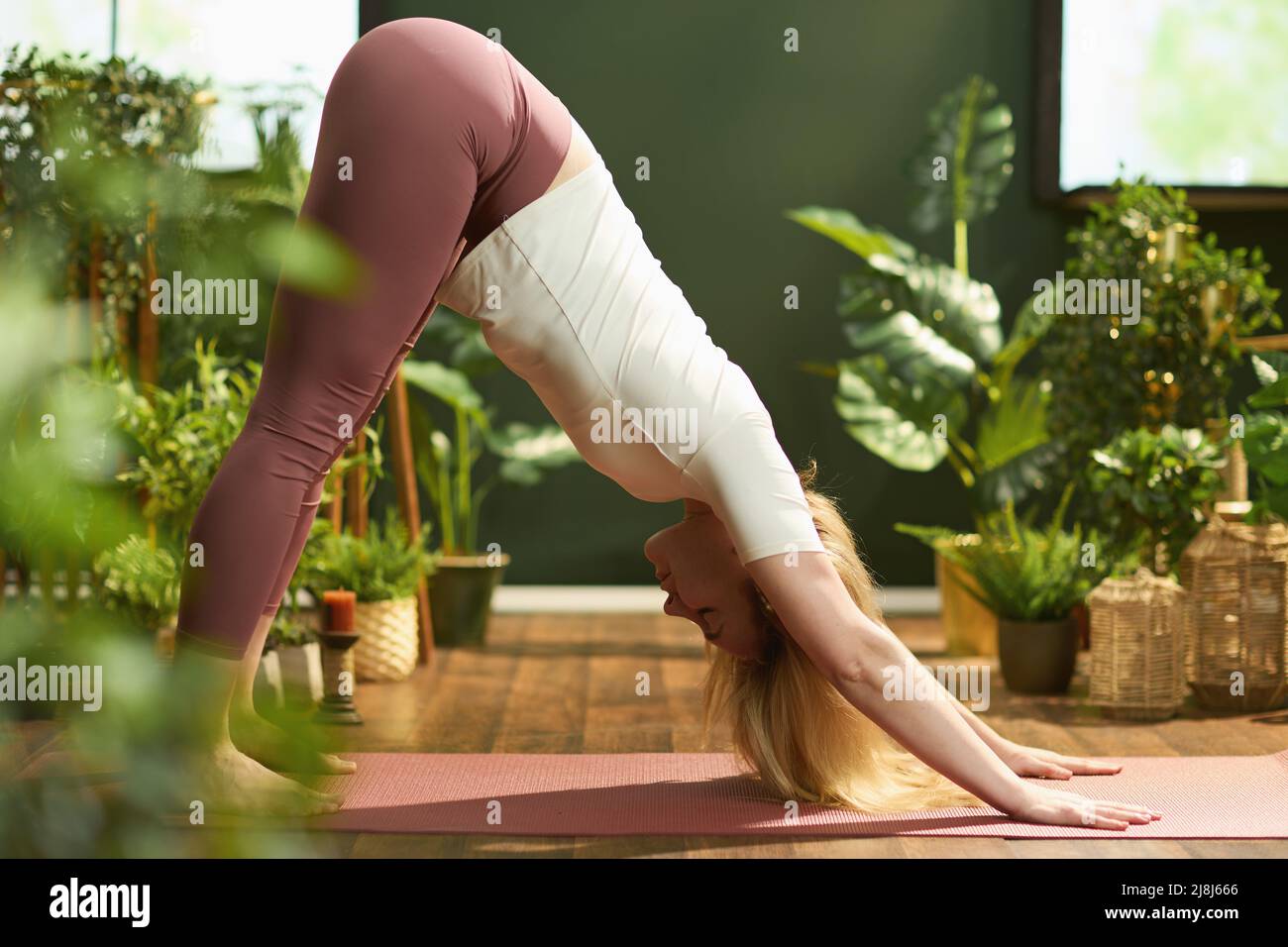 modern woman in the modern green living room stretching Stock Photo - Alamy