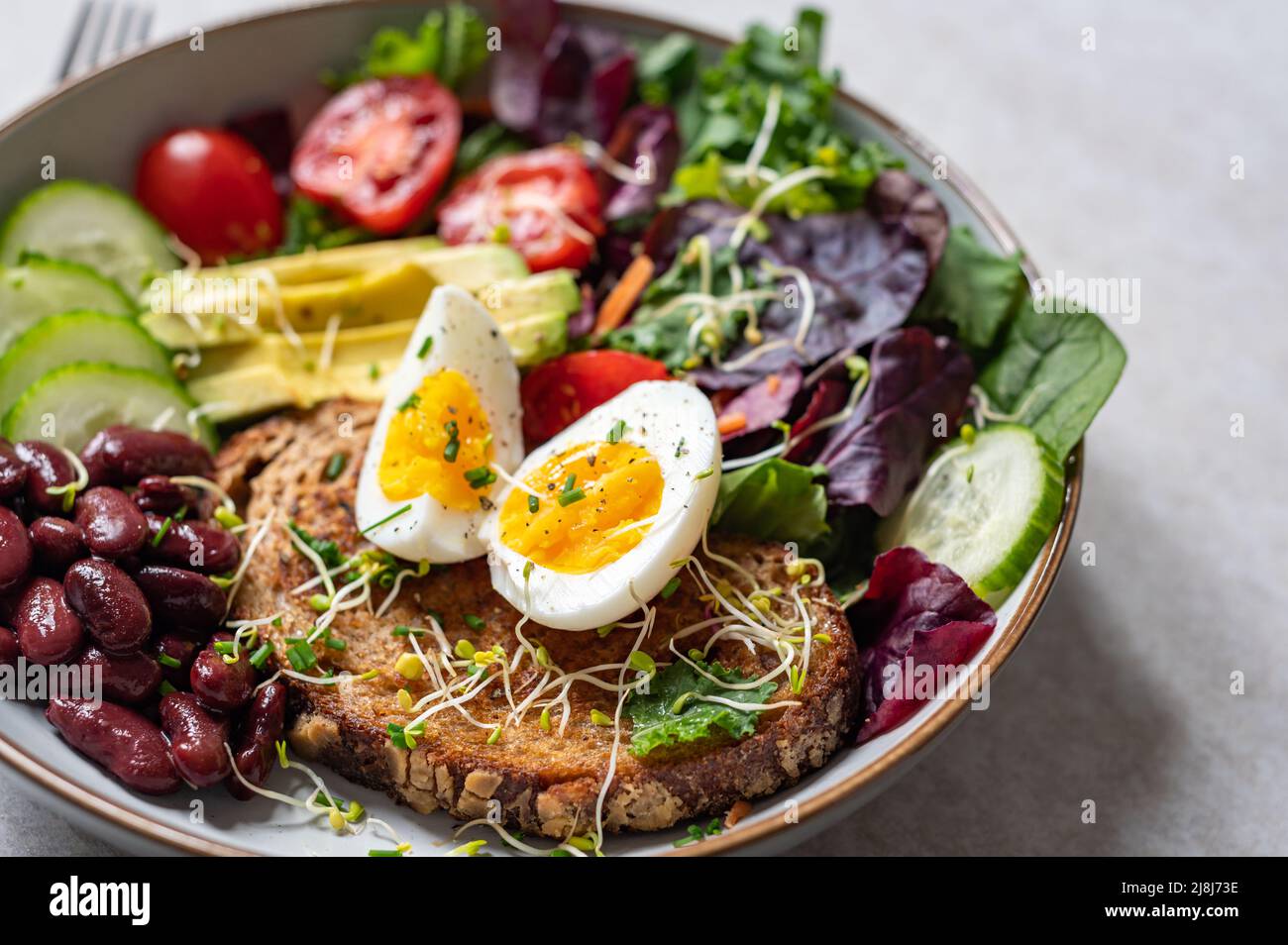 Medium boiled eggs with sasld, healthy breakfast Stock Photo