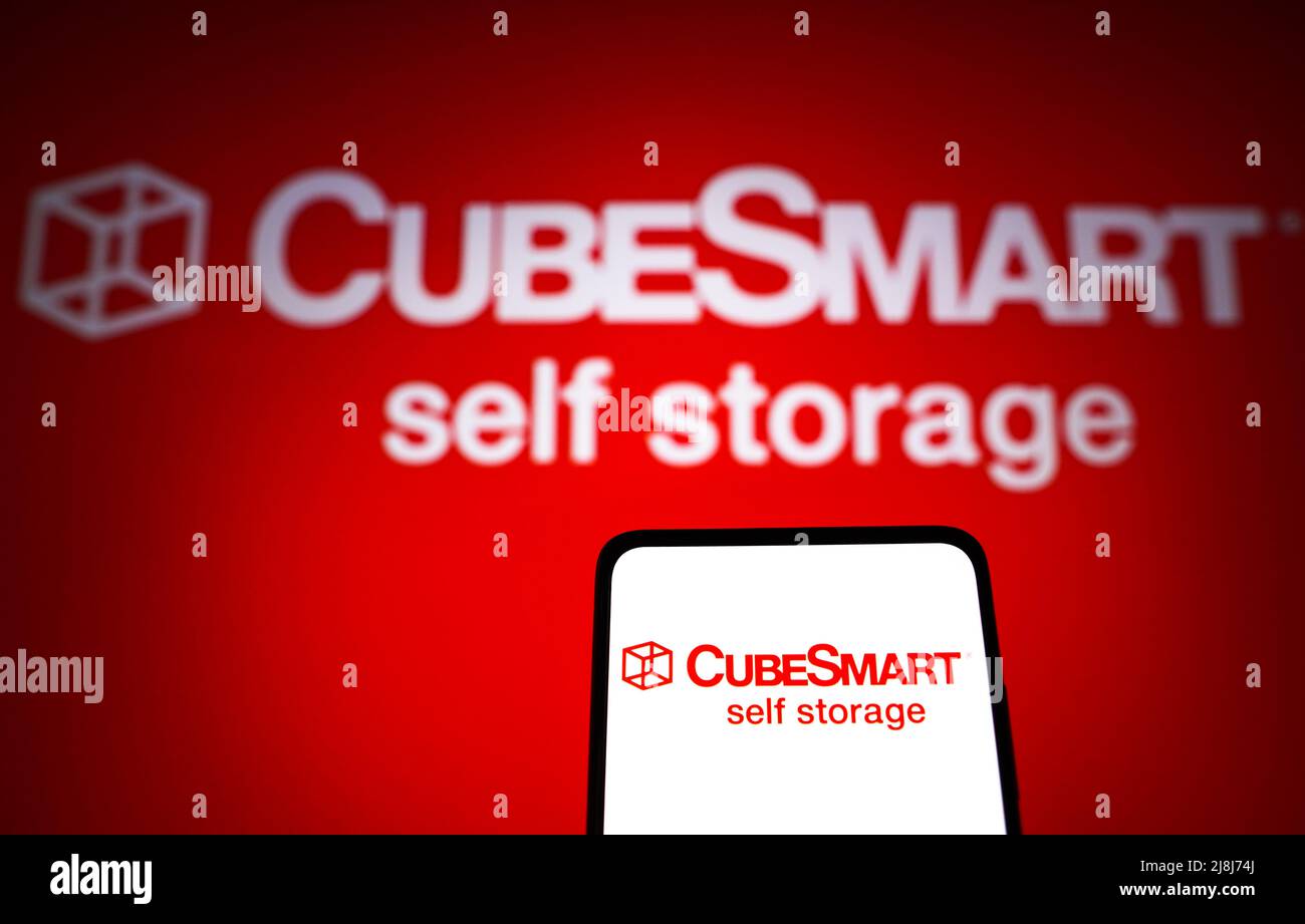 In this photo illustration the CubeSmart logo seen displayed on a