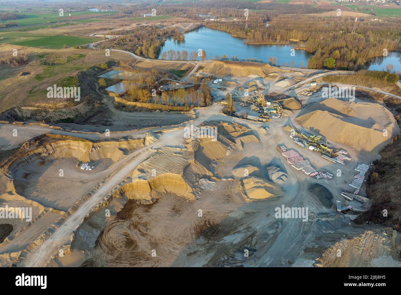 Aerial view of open pit mining of limestone materials for construction industry with excavators and dump trucks Stock Photo