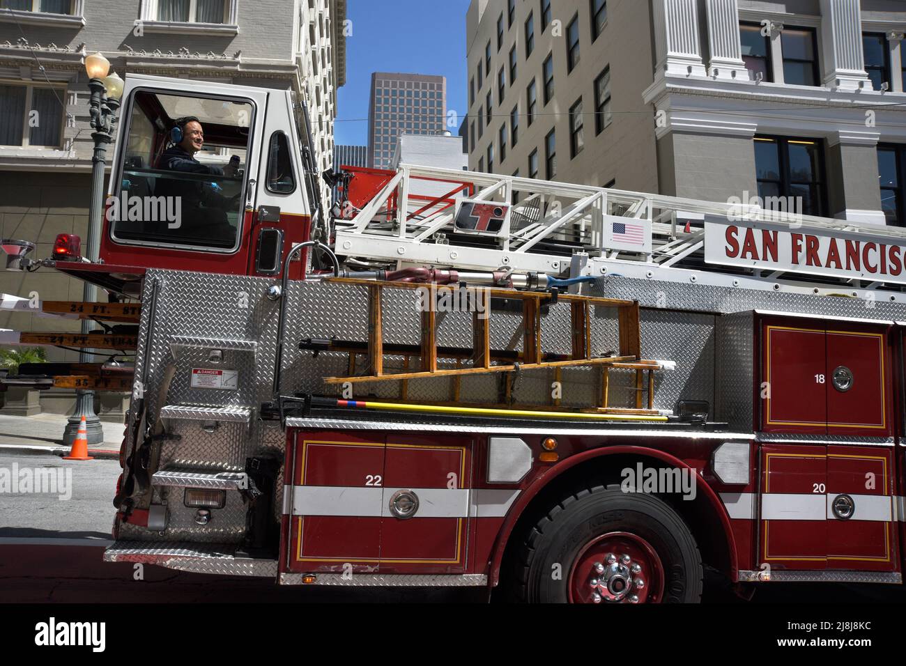 A tiller fire truck with steering wheels both the front and back moves  along a street in San Francisco, California. A tillerman sits in the rear  Stock Photo - Alamy