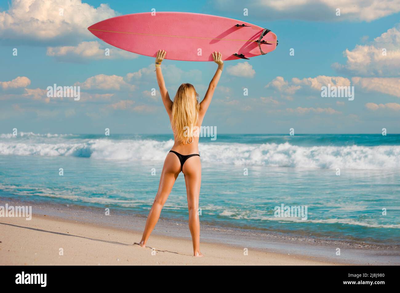 A beautiful girl at the beach with her bodyboard Stock Photo