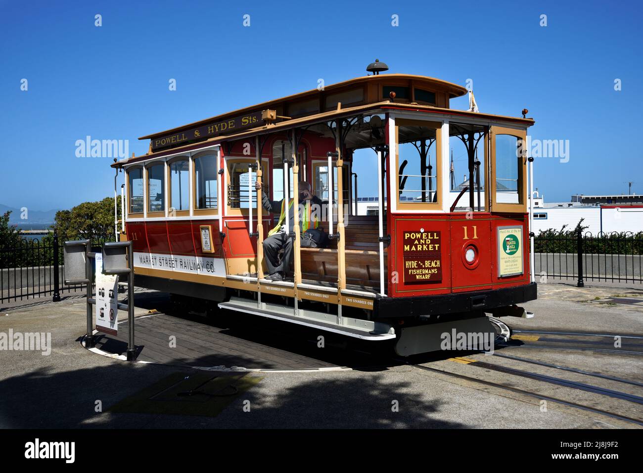A cable car operator rests while waiting for his turn to accept passengers in San Francisco, California. Stock Photo