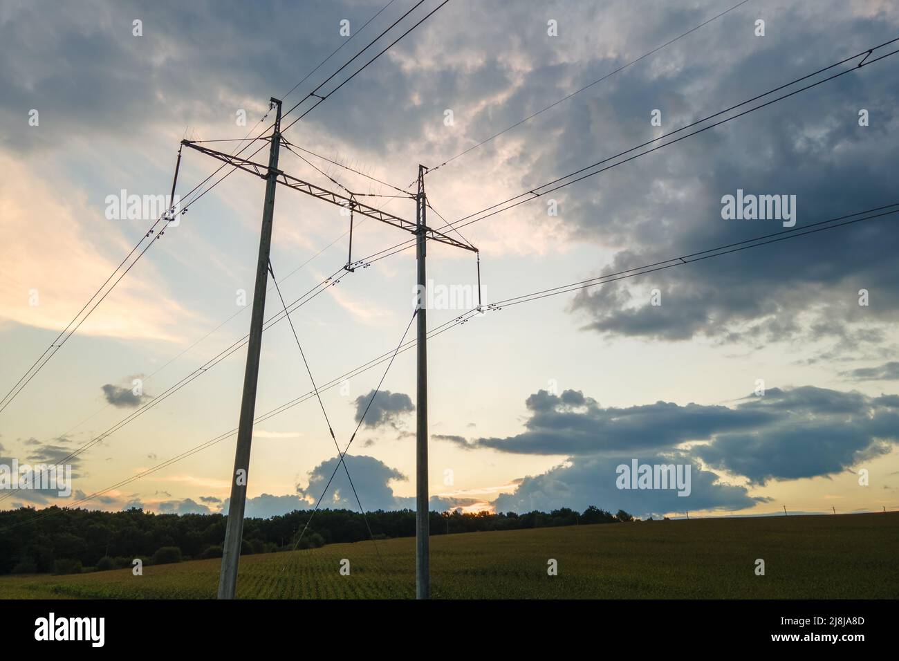 High voltage tower with electric power lines at sunset Stock Photo - Alamy