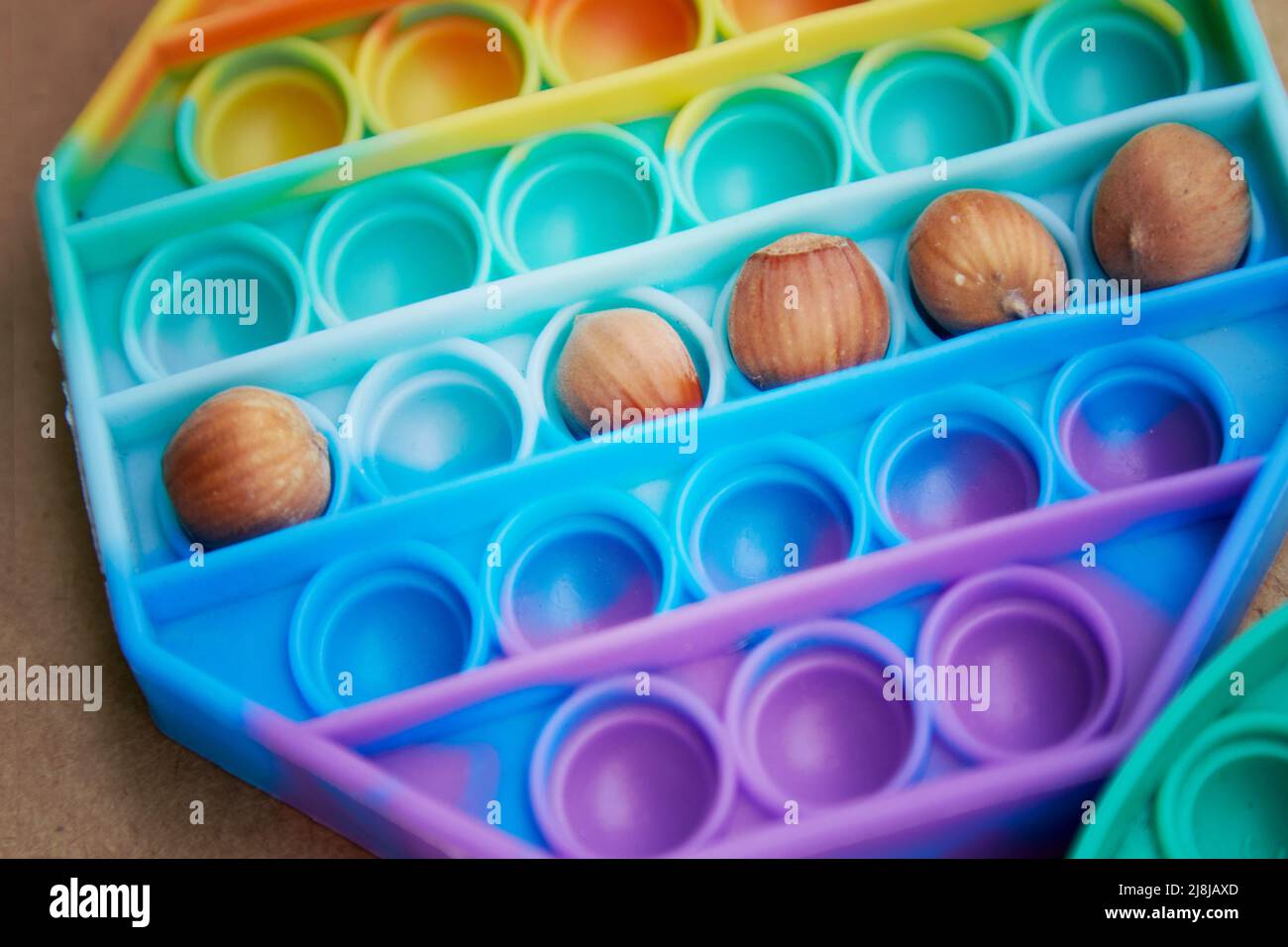 Pop it toy with hazel nuts. Invented games for motor skills development