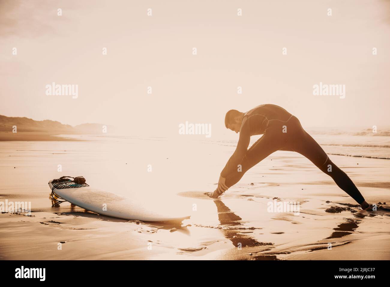 A surfer warming up before going surf Stock Photo