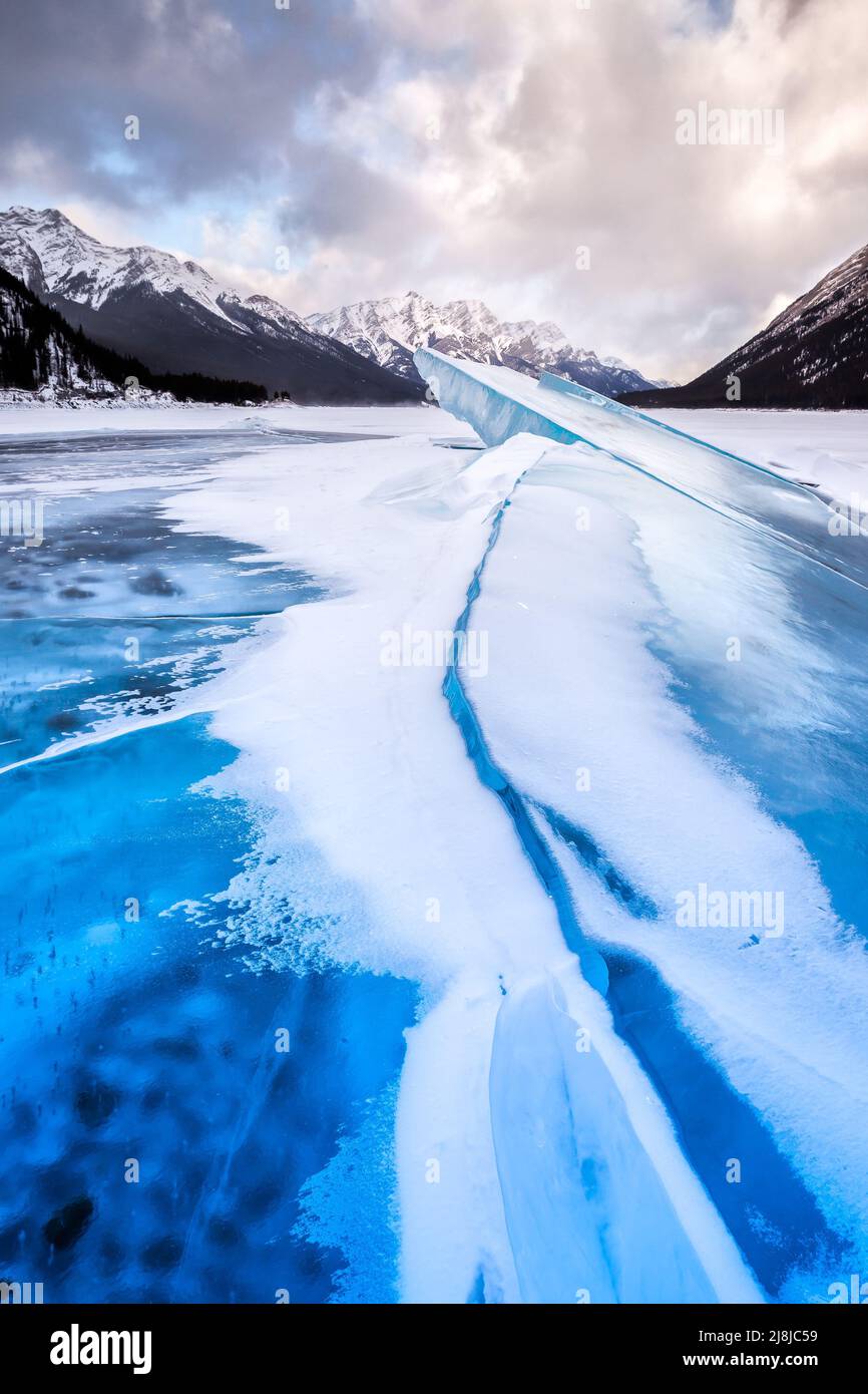 Bulged, cracked ice on the Spray Lakes Reservoir in Spray Lakes Provincial Park, Kananaskis Country, Alberta, Canada. Stock Photo