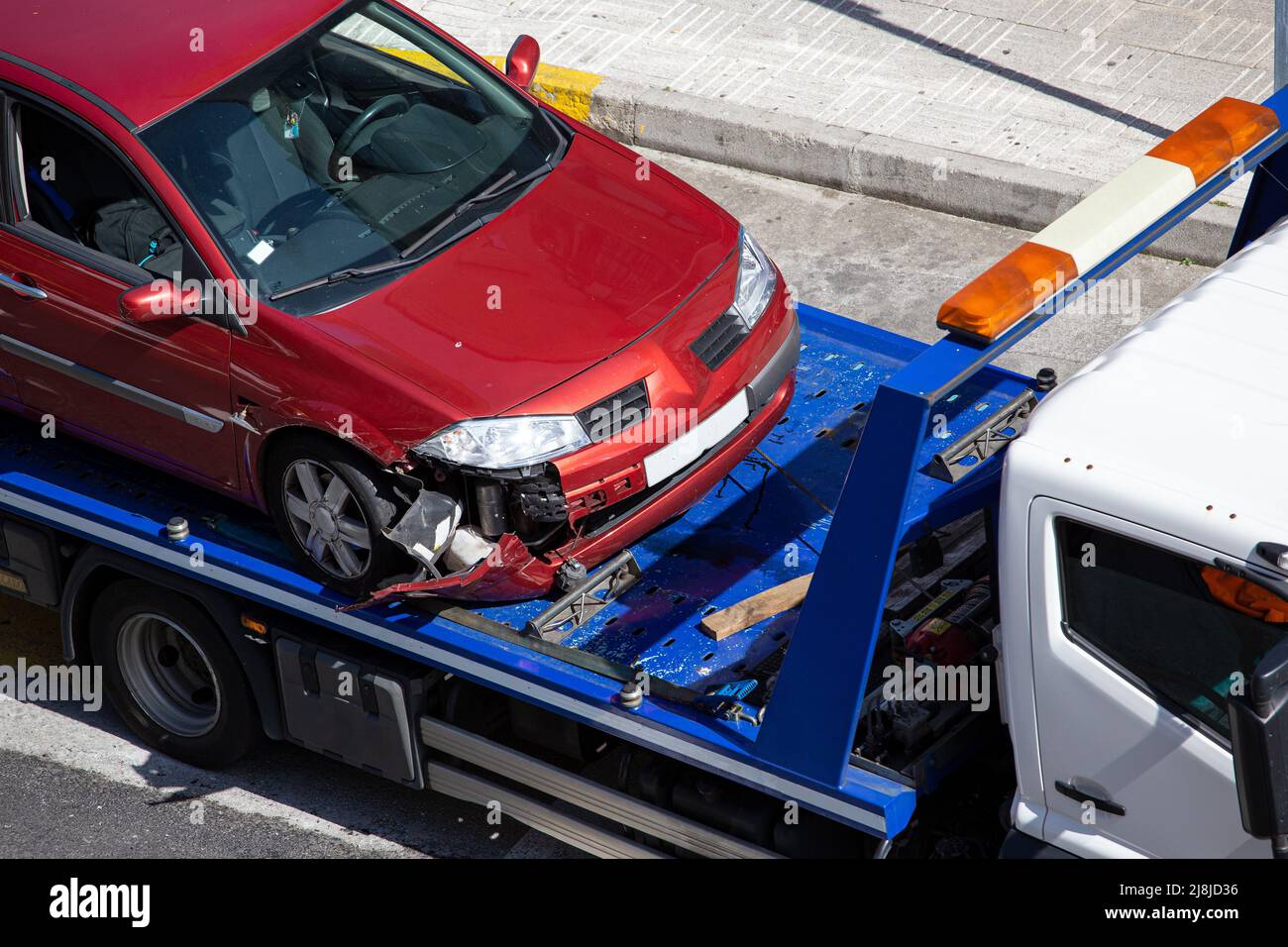 Crashed car loaded on a tow truck. Damage vehicle after crash accident