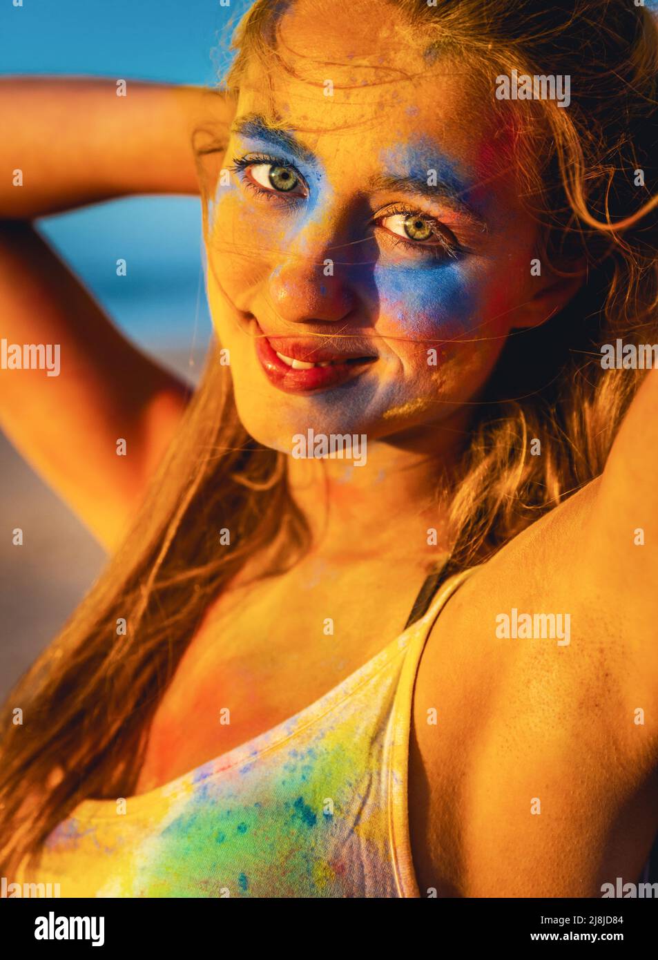 Portrait of a beautiful girl full of colored powder on the face Stock Photo