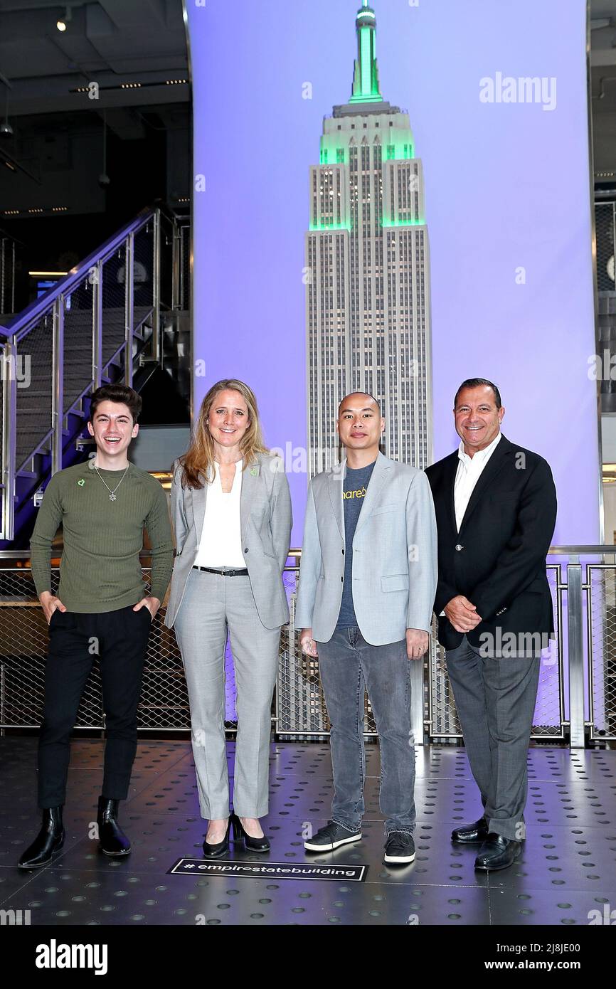 New York, NY, USA. 16th May, 2022. Eitan Bernath, Jennifer McLean, Chief Operating Officer, City Harvest, Will Pang, VP of Finance, Sharebite, Jean-Yves Ghazi, President of the Empire State Building Observatory at the ceremonial lighting of the Empire State Building in green, to celebrate City Harvests 20th Share Lunch Fight Hunger campaign to raise awareness around child hunger in NYC at The Empire State Building. Credit: Steve Mack/Alamy Live News Stock Photo