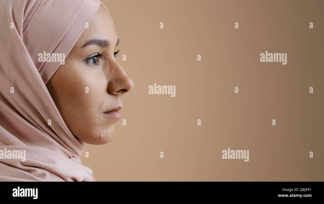 Close up profile portrait face of arab saudi woman muslim lady in stylish headscarf beautiful asian girl model businesswoman wear traditional islamic Stock Photo