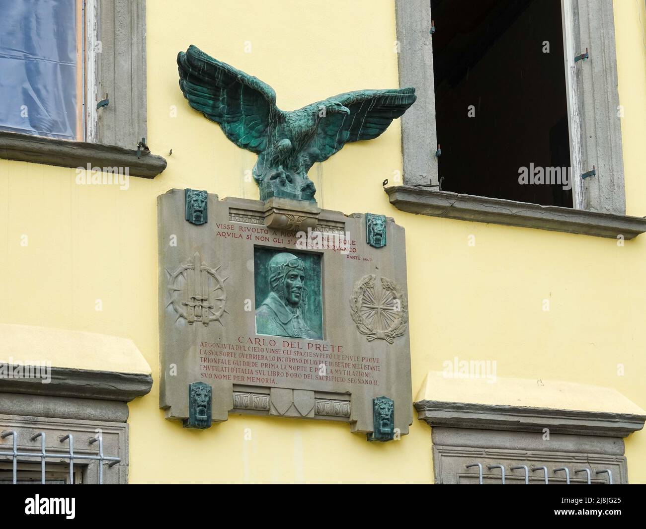 Memorial plaque with a bronze relief portrait, on the top a console with a bronze eagle. Memorial for aviator, Carlo del Prete, Lucca, Italy. Stock Photo