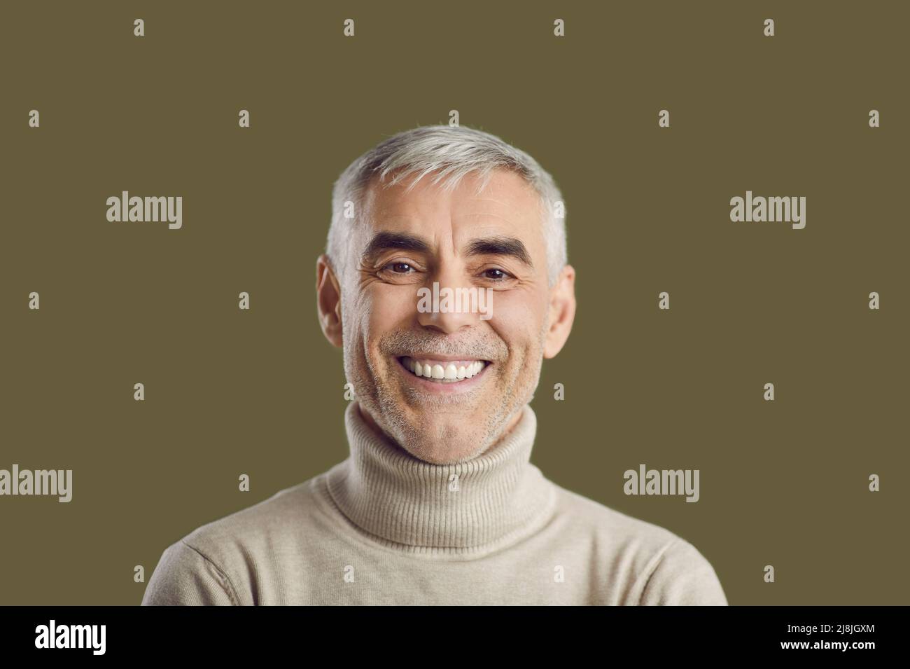 Close up portrait of happy white-haired man with positive sincere smile and friendly expression. Stock Photo