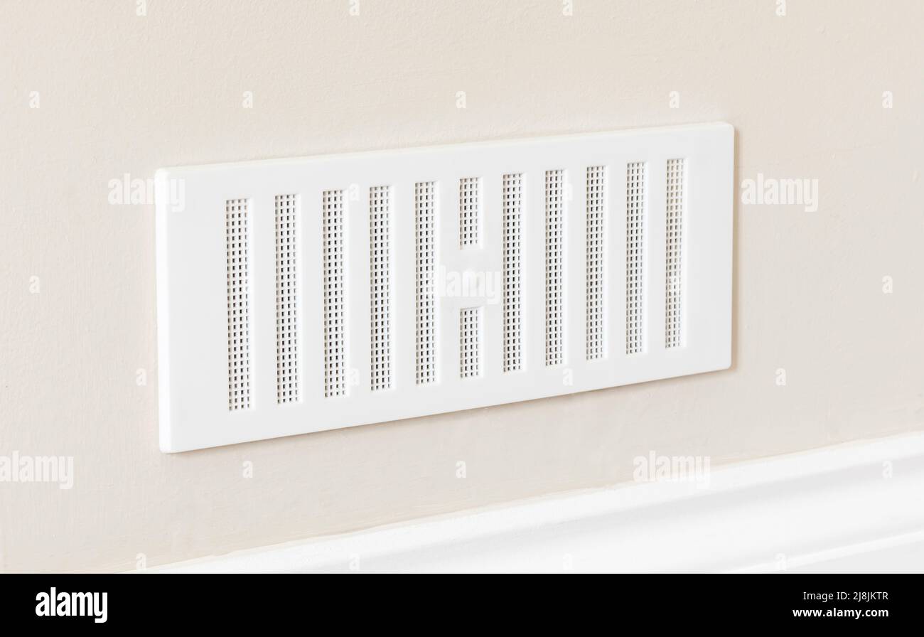 Adjustable air vent cover on the wall of a house. UK home ventilation with brick vents to improve air flow. Stock Photo
