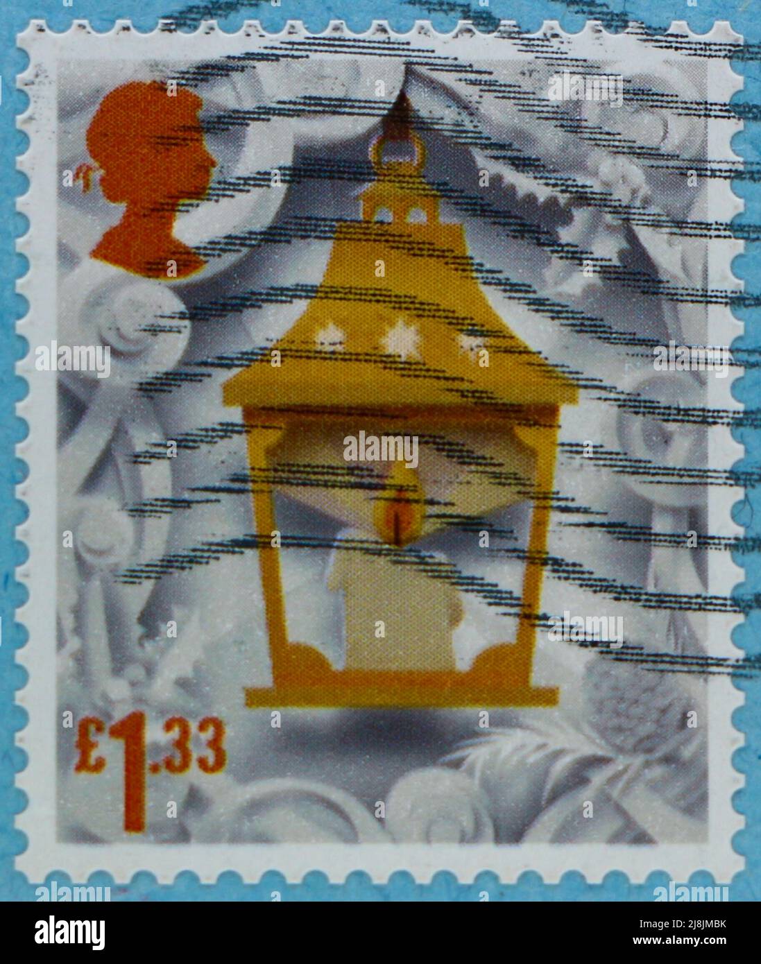 Photo of a British Christmas stamp with an image of a candle in a lamp Stock Photo