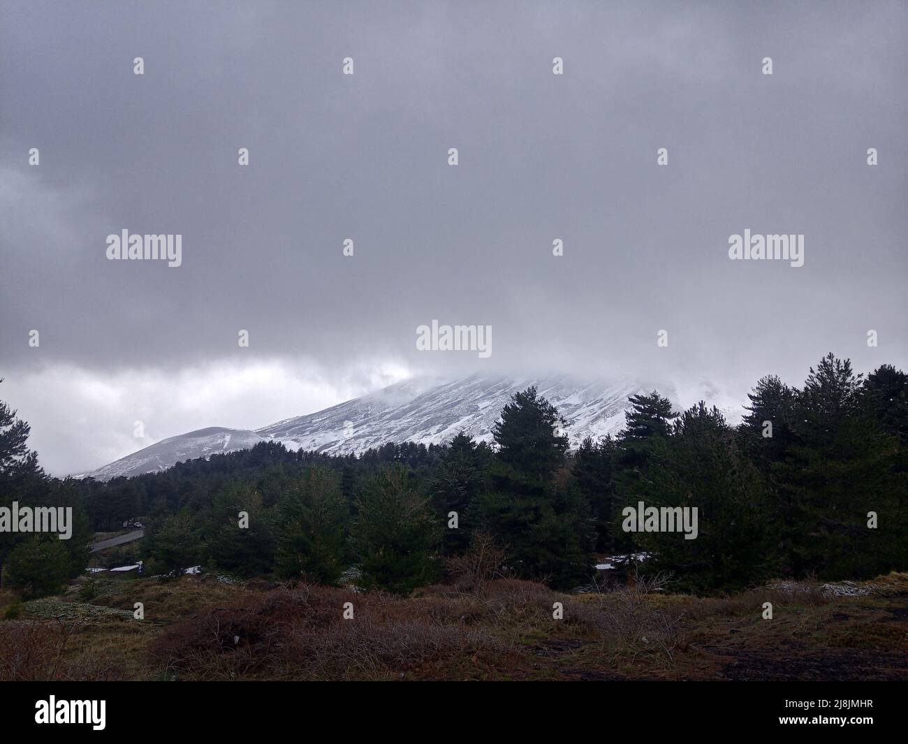 Dark landscape with moody weather on the Mt Etna with overcast sky