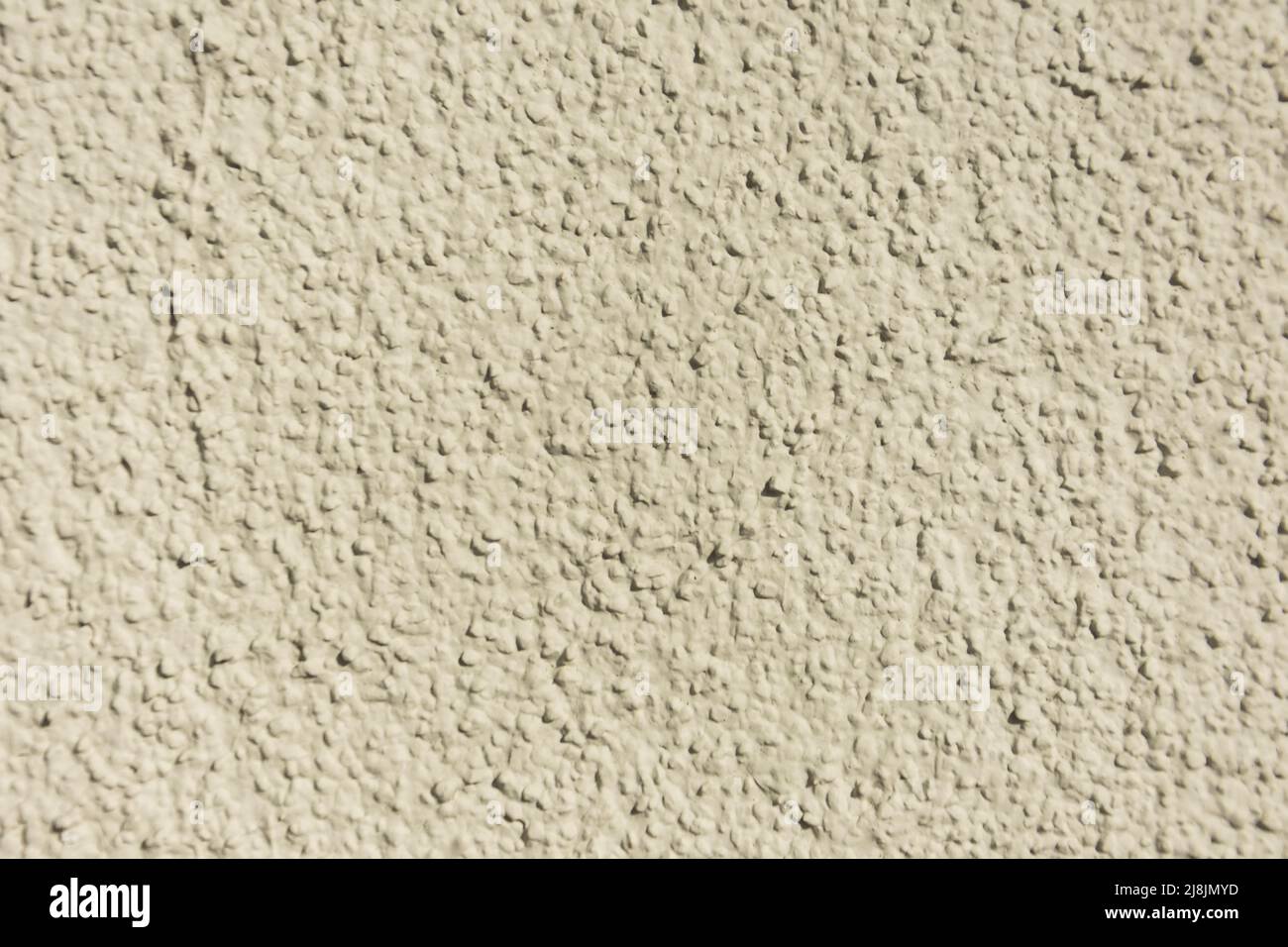 Rough uneven, texture beige concrete a wall Stock Photo