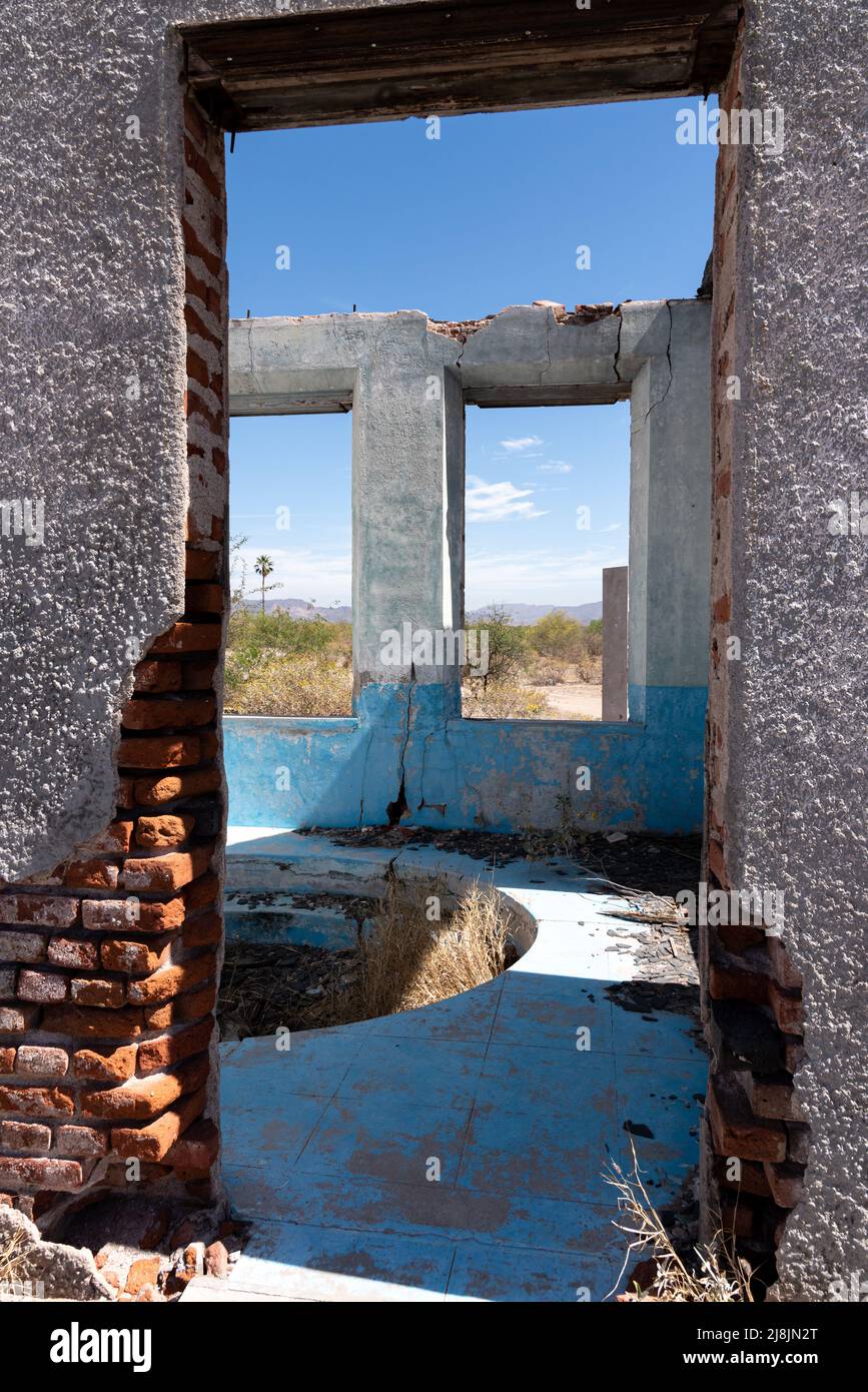 Looking through the doorway of an abandoned stucco building in the Sonora Desert in Mexico. Stock Photo