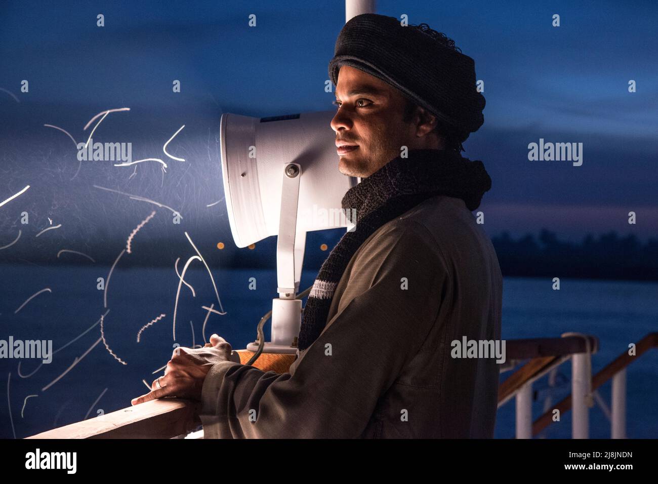 crem member on a Nile Dahabiya boat at night near the spotlight Stock Photo