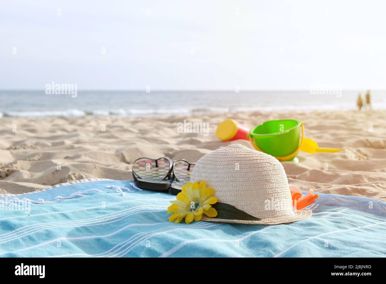 Hat and flip flops on sandy beach Stock Photo - Alamy