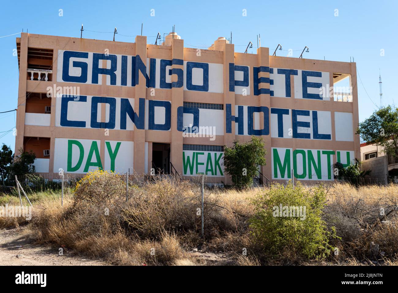Rundown three-story Gringo Pete Condo Hotel with misspelled word weak instead of week, in San Carlos, Sonora, Mexico. Stock Photo