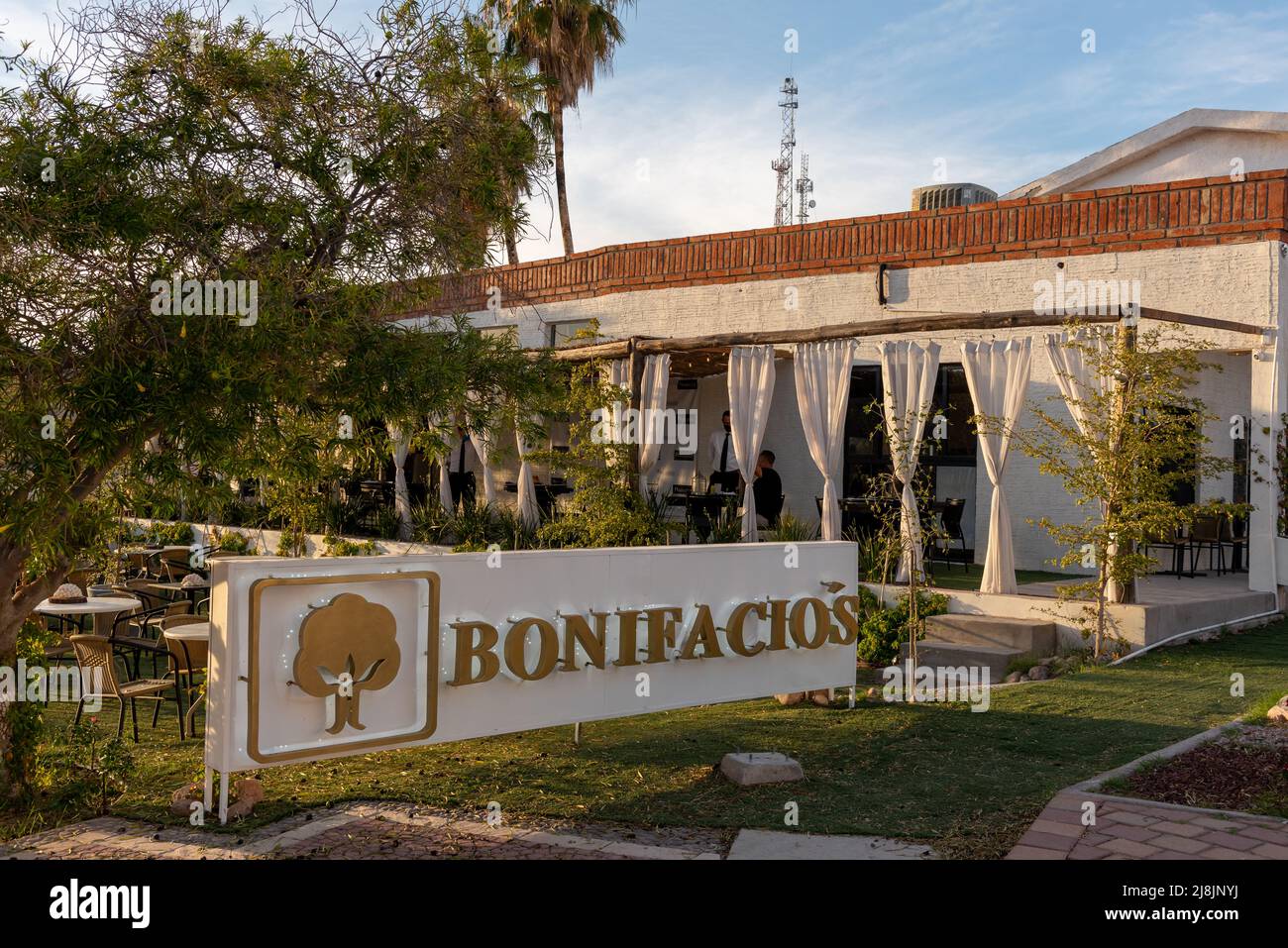 Exterior of Bonifacio’s, a fine-dining restaurant with outdoor seating framed by curtains, in San Carlos, Sonora, Mexico. Stock Photo
