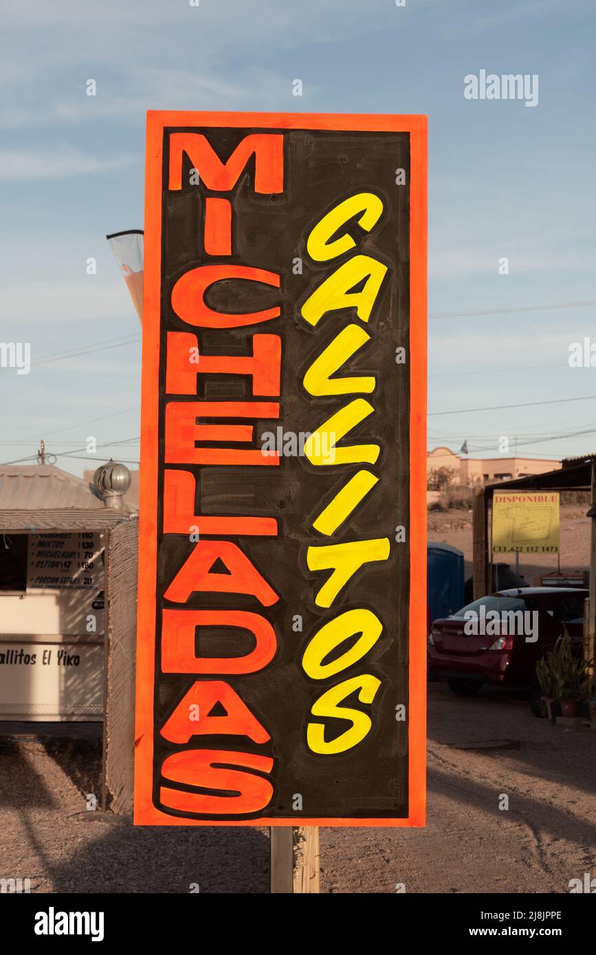 Sign advertises micheladas, traditional spicy mexican beer and tomato juice cocktail, and callitos, San Carlos, Sonora, Mexico. Stock Photo