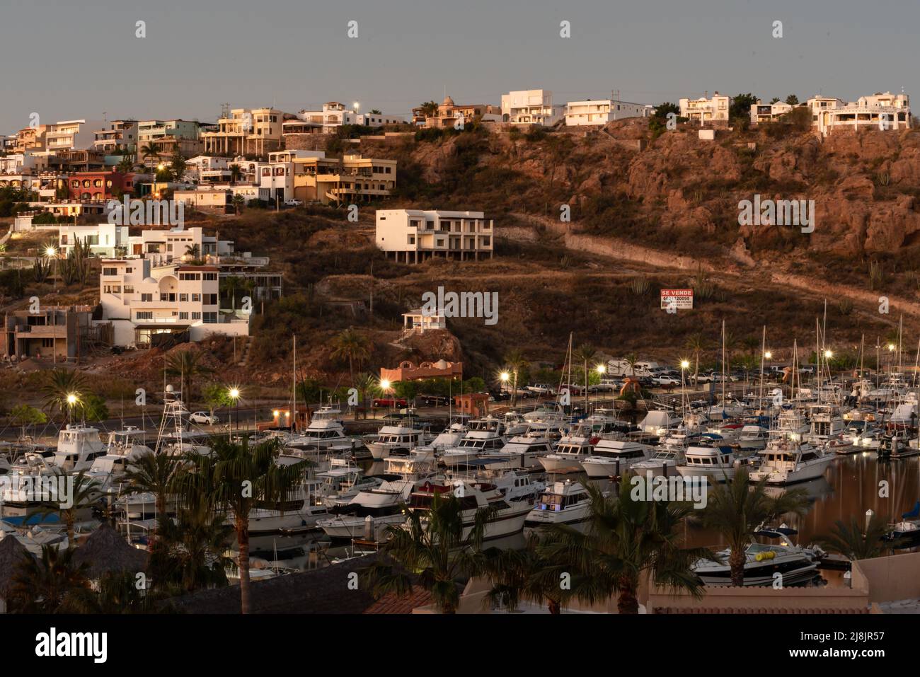 Looking down on boats in San Carlos Marina and homes on a hill in the ...