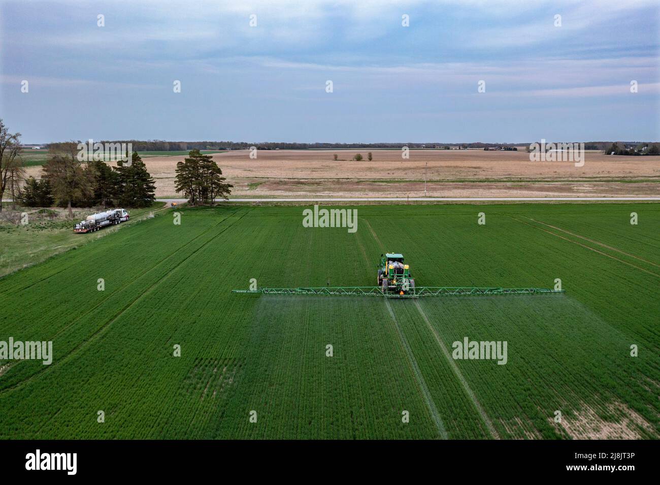 Pinnebog, Michigan - A sprays fungicide on a wheat field in Michigan's thumb. Stock Photo