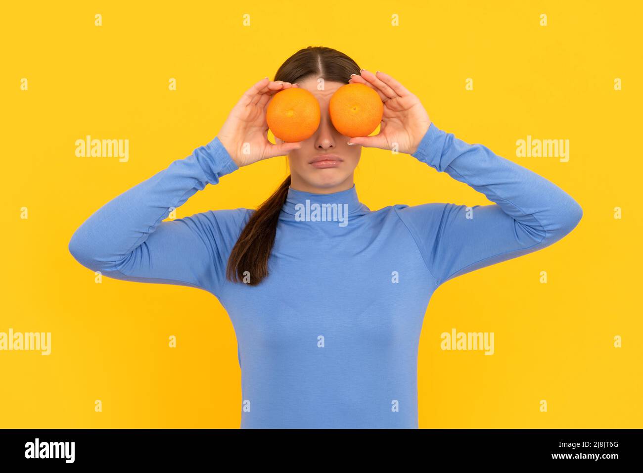 funny girl with orange citrus fruit. vitamin and dieting. woman holding healthy food. Stock Photo