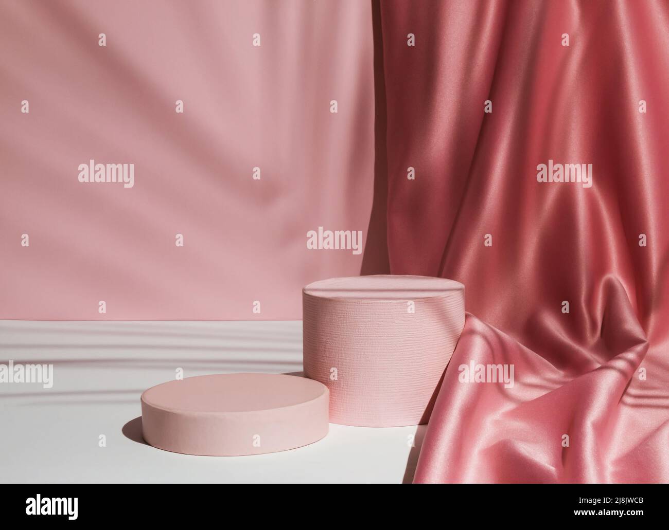 Pastel pink composition with satin curtain and palm leaf shadow ...