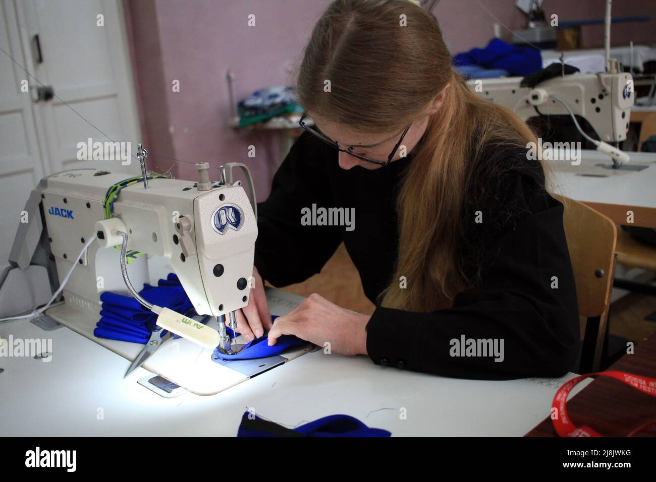 Odessa, Ukraine. 24th Mar, 2022. A young seamstress volunteer sews