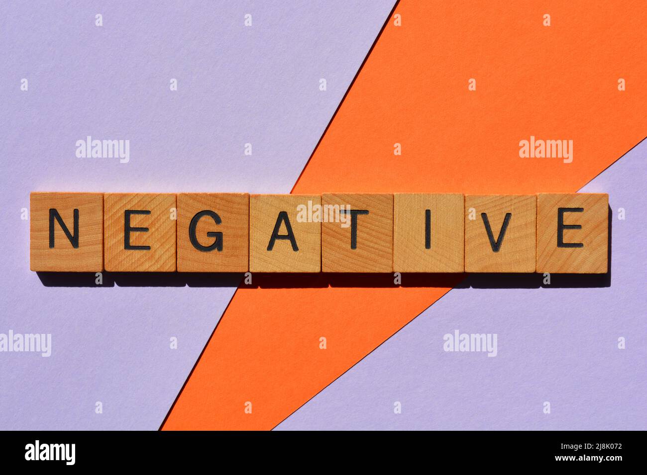 Negative, word in wooden alphabet letters isolated on colour background Stock Photo