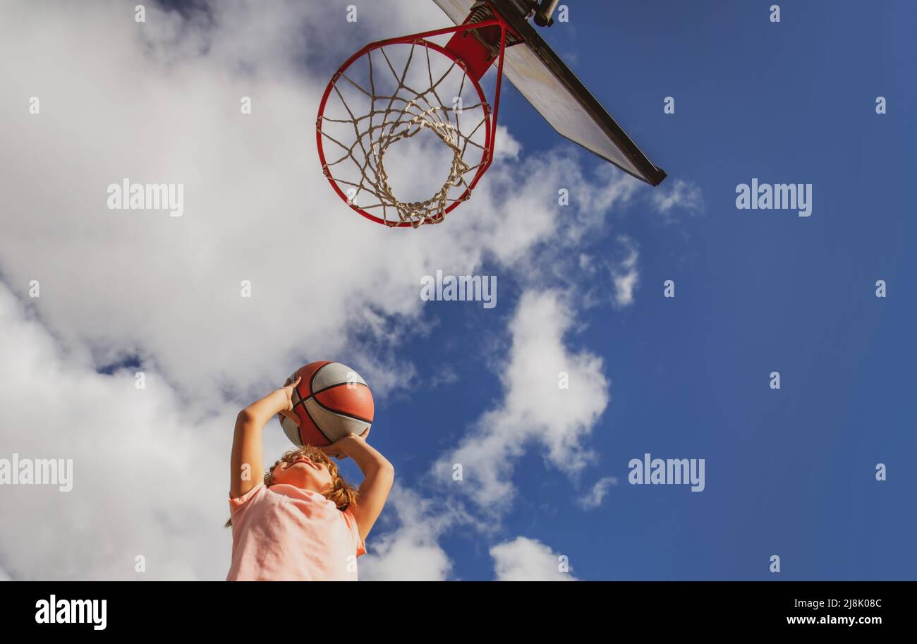 Kid boy concentrated on playing basket ball Stock Photo Alamy