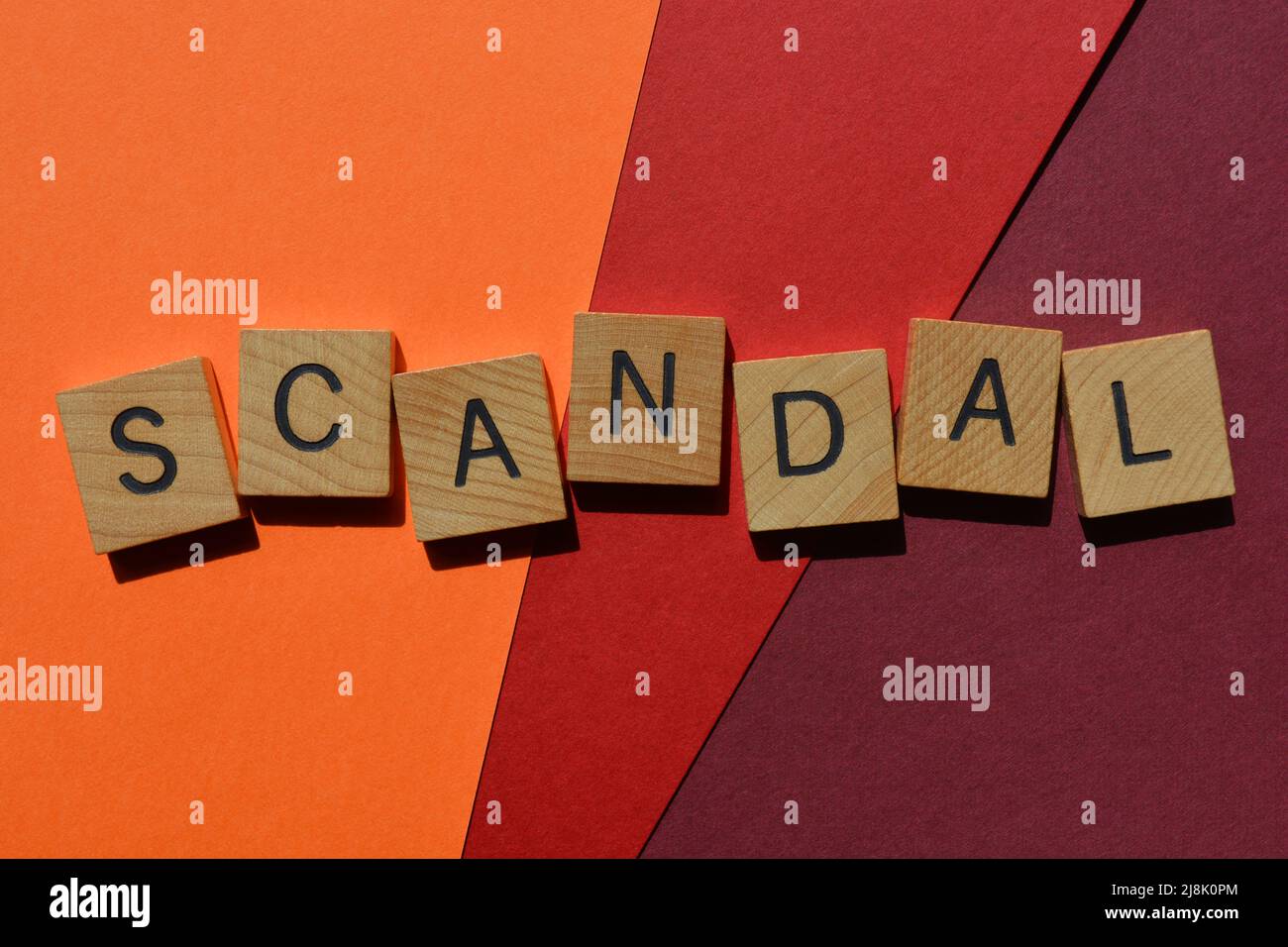 Scandal, word in wooden alphabet letters isolated on background Stock Photo