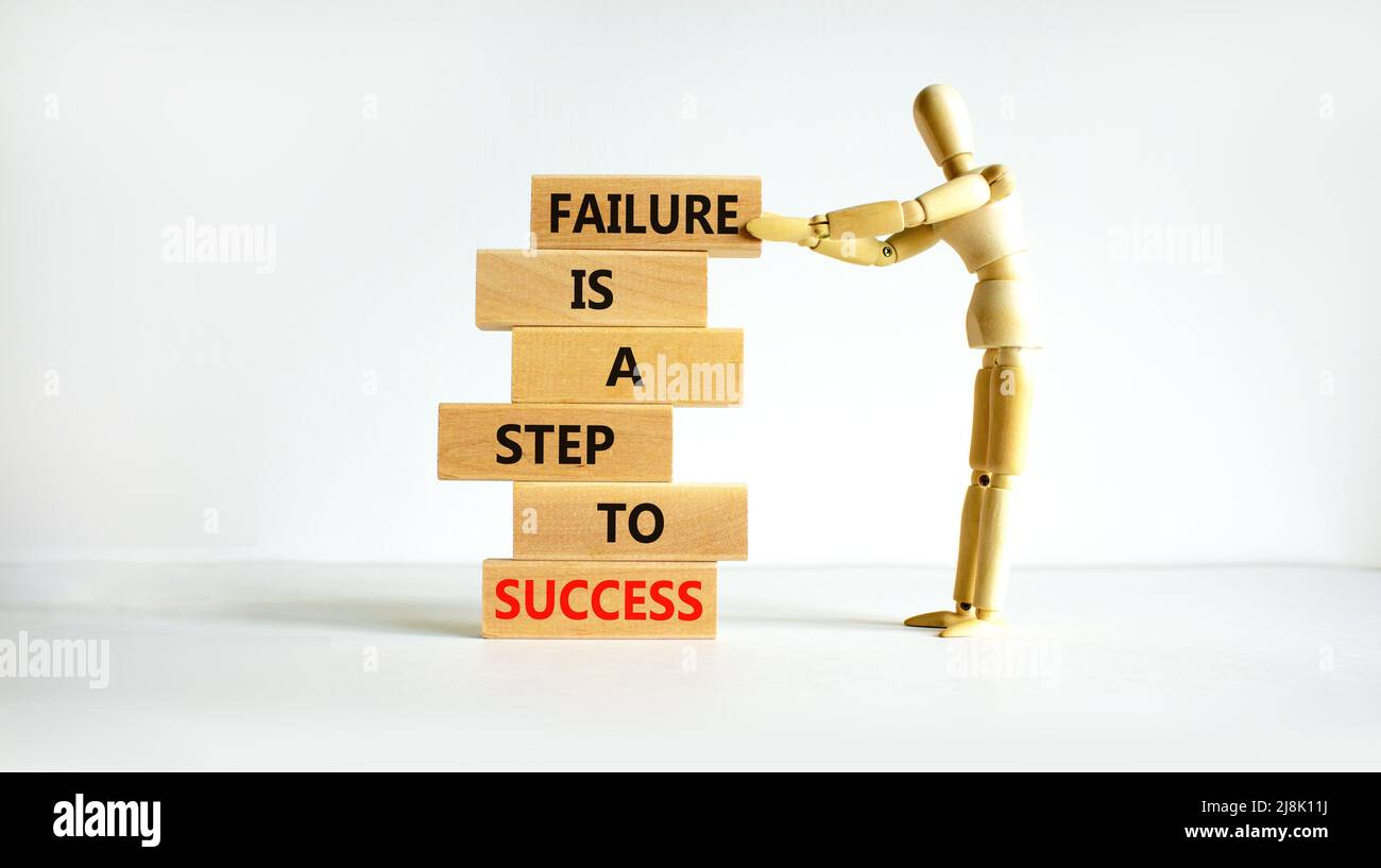 Failure or success symbol. Wooden blocks with words A failure is a step ...