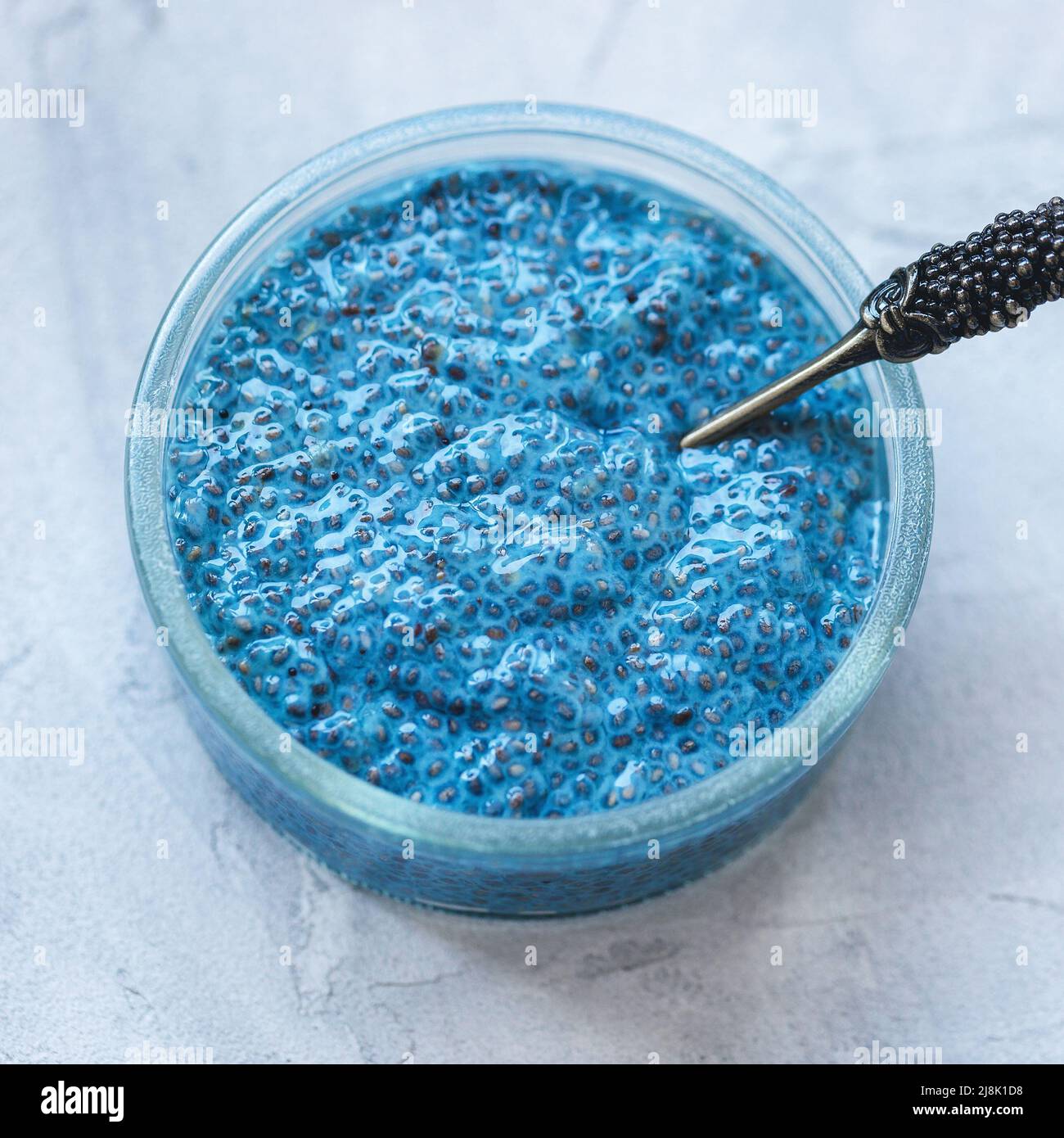 Blue spirulina chia seed pudding bowl with spoon. Superfood and vegan