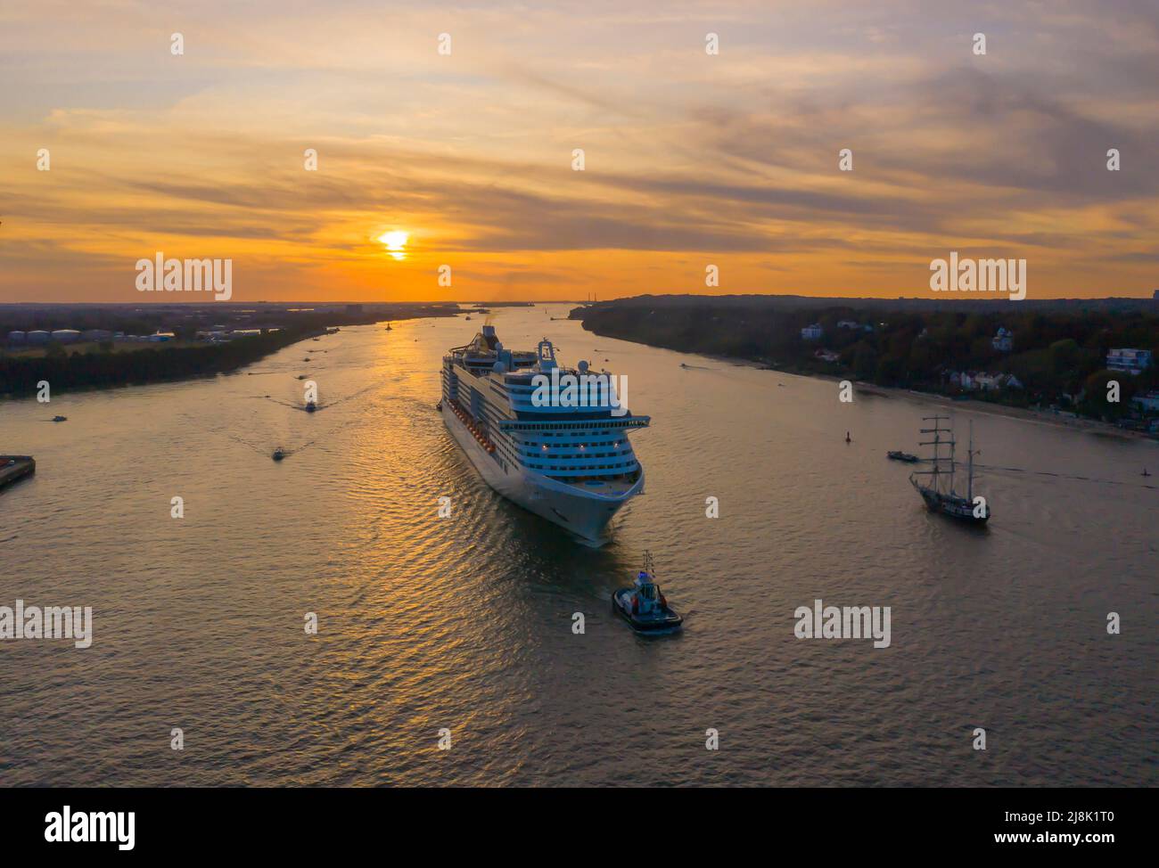 Cruiser of shipping company MCS hauled on the Elbe by a towboat