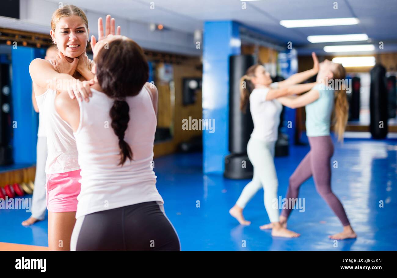 Two women practicing palm strike in sparring in gym Stock Photo