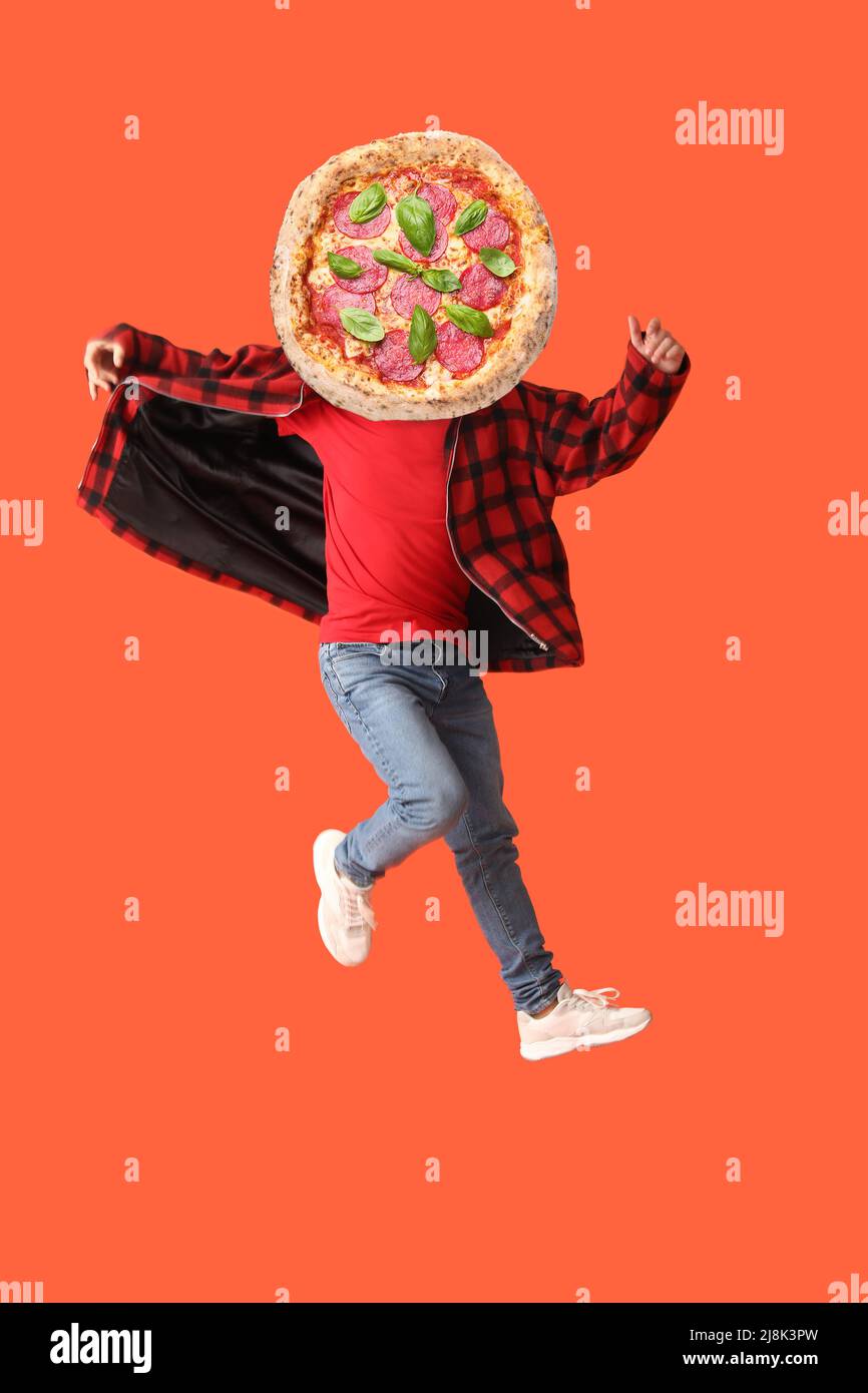 Jumping young man with tasty pizza instead of his head on color background Stock Photo