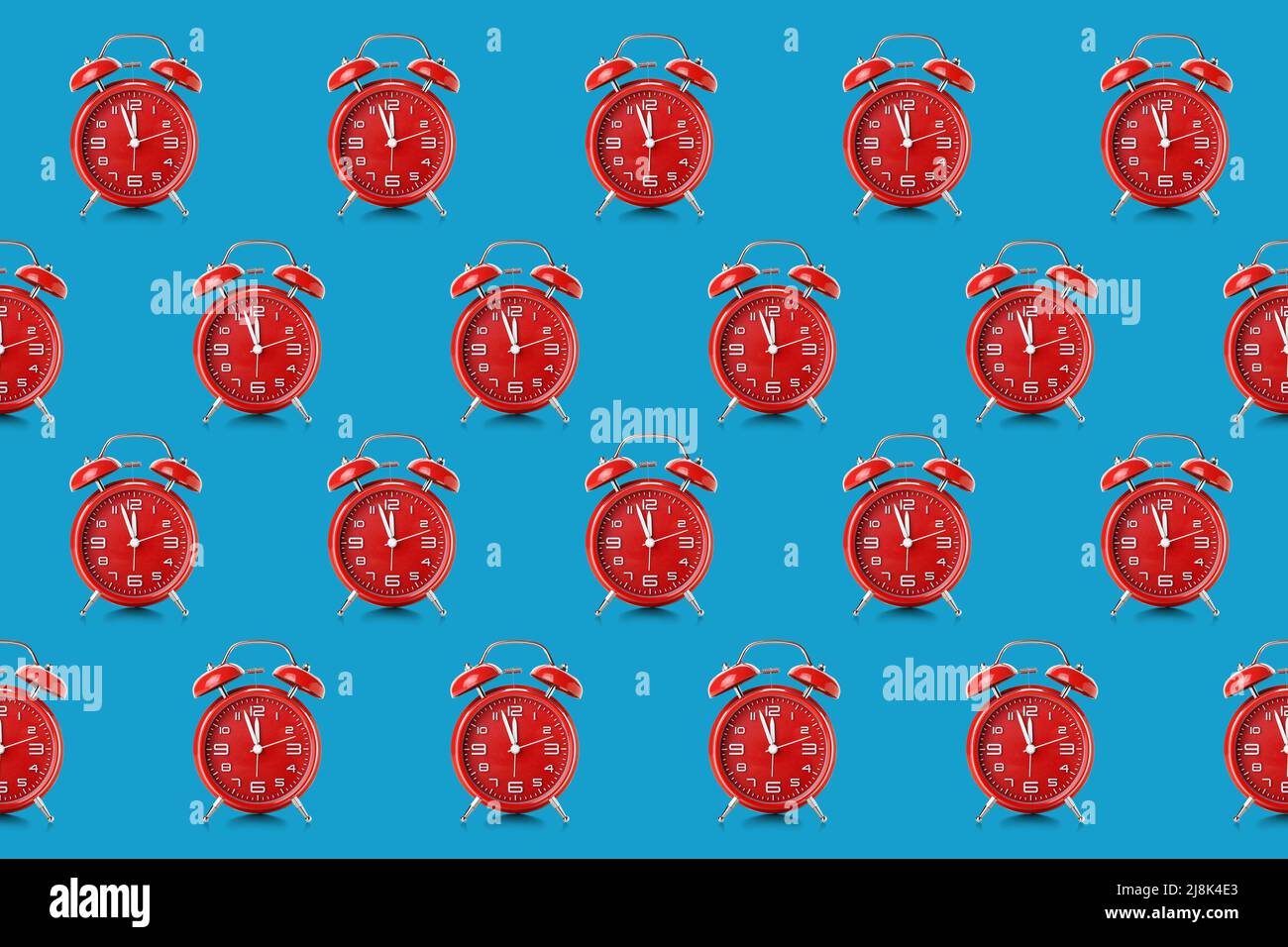Many alarm clocks on blue background. Pattern for design Stock Photo ...